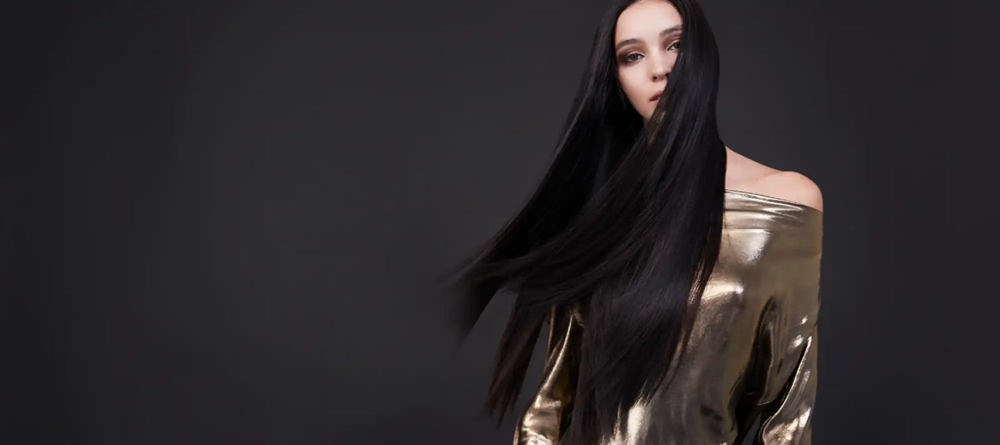 Femeie cu păr lung negru în top de aur.